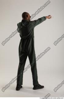 ERIC STANDING POSE WITH GUNS